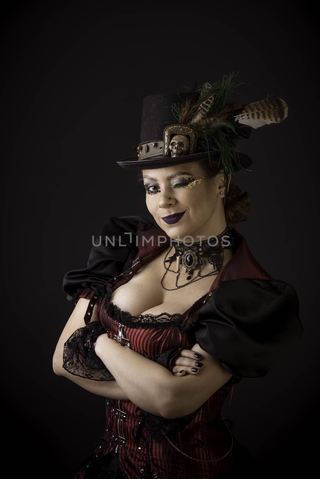 Emotional Portrait of Young Woman in Steampunk or Retro style. Studio shot. Model on a Black Background