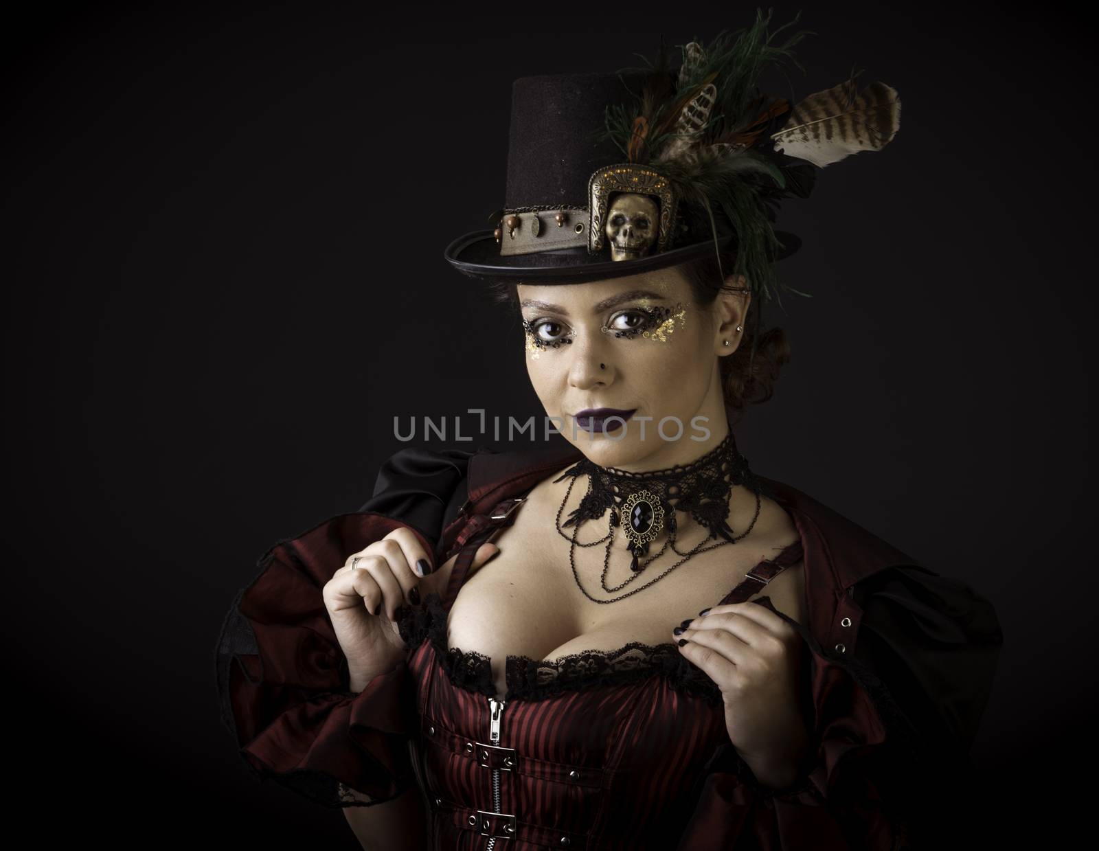 Emotional Portrait of Young Woman in Steampunk or Retro style. Studio shot. Model on a Black Background