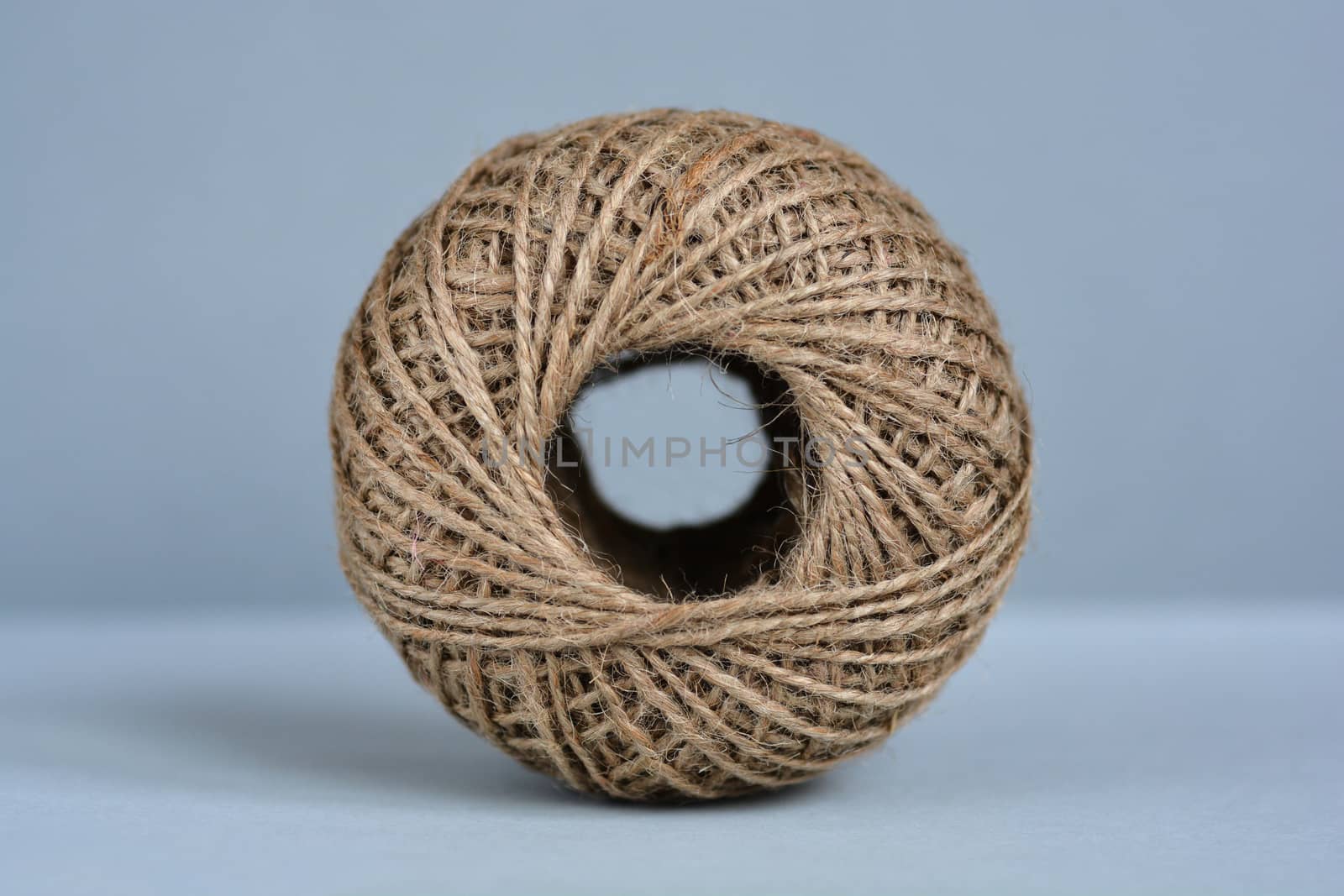 Close up of ball of rope on blue gray background