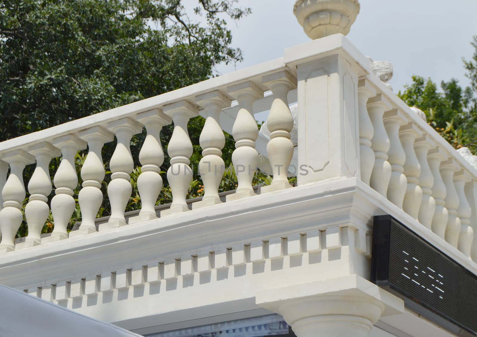 View of the romantic white balcony, terrace with balusters, white stone railing.