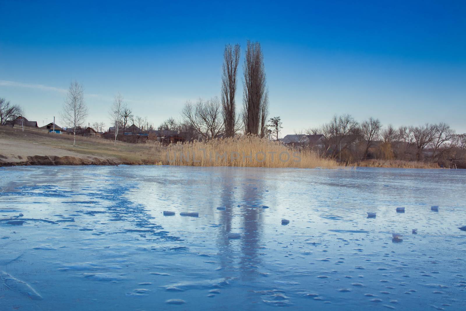 Winter paysage landscape of frozen village on iced lake  by VeraVerano