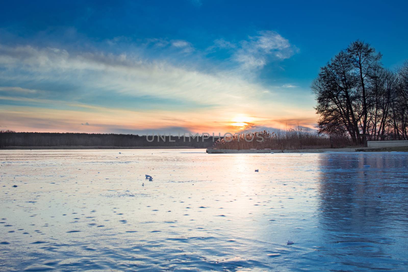 Winter paysage landscape of sunset evening iced frozen lake river