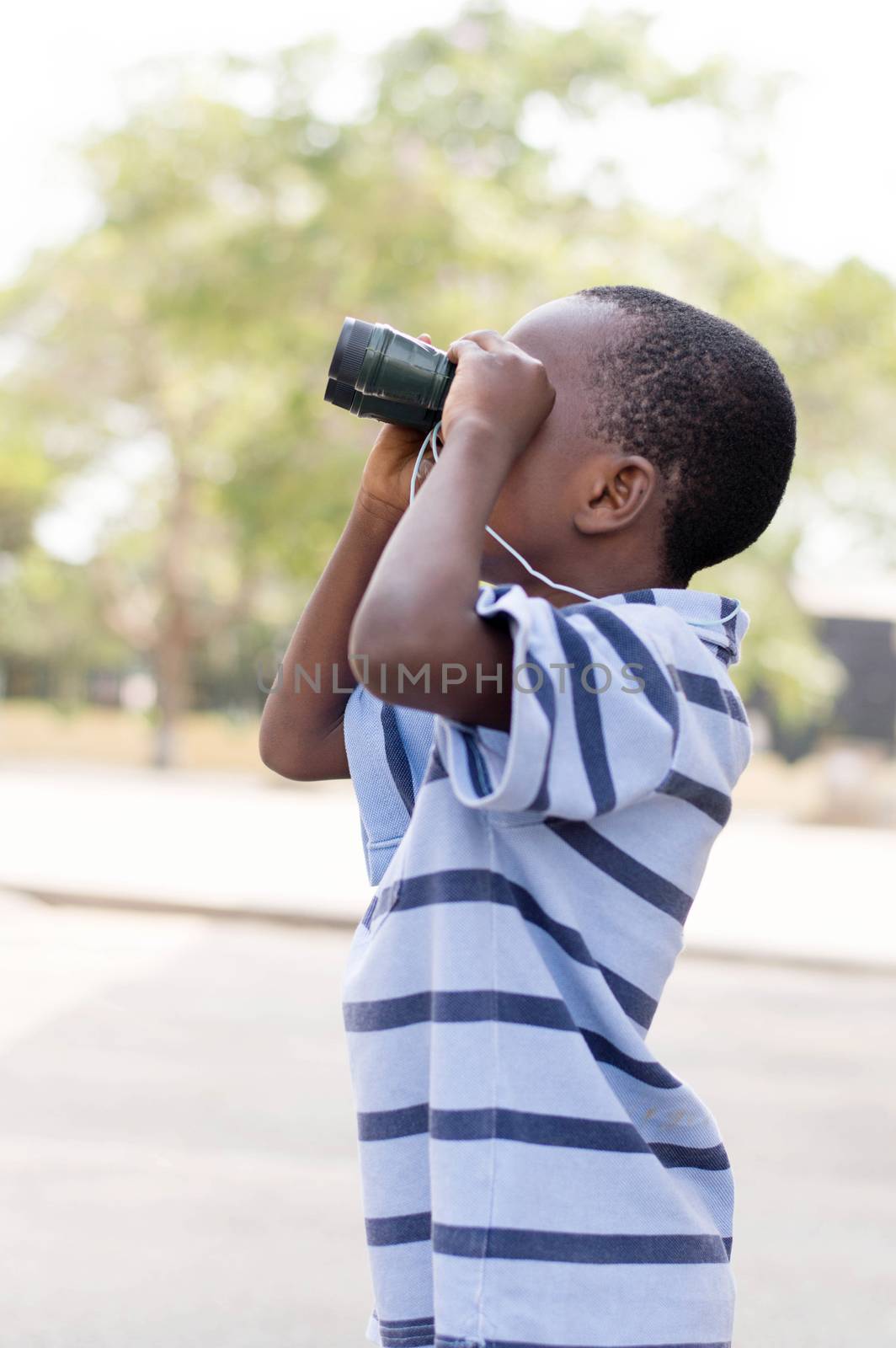 child looks through the binoculars to search his mark.