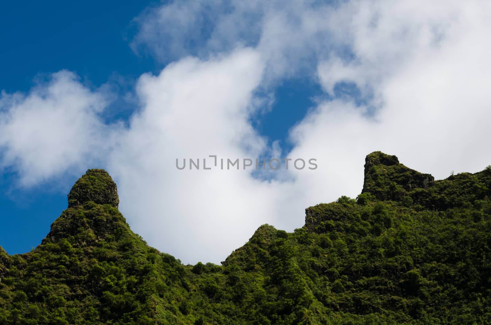 Mountain crest against clouds and sky in Kalalau trail, Hawaii,  by mikelju