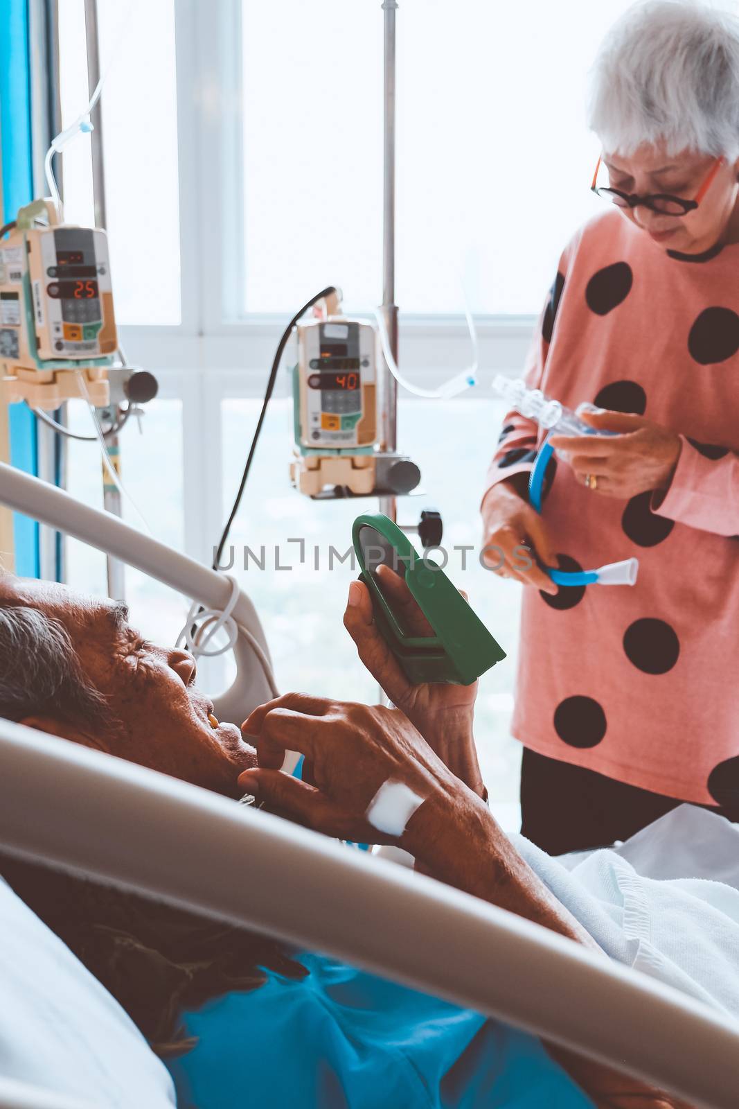 Elderly patients relax in hospital bed