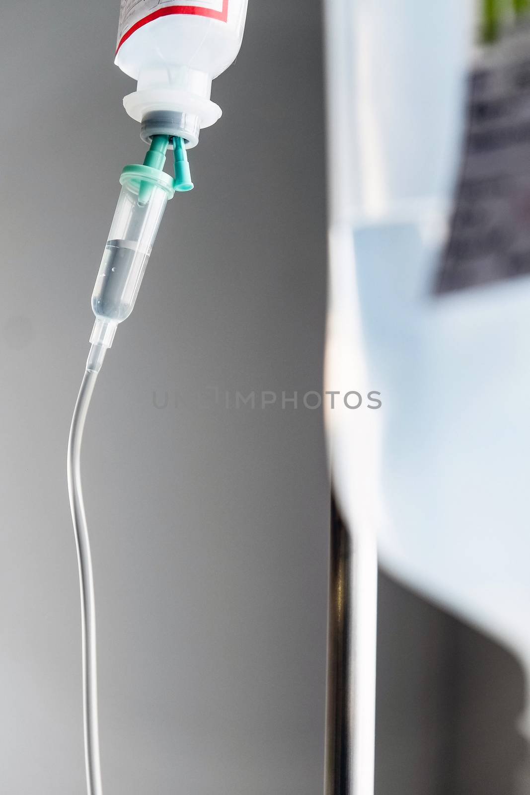 Close up of IV saline solution drip for patient in hospital