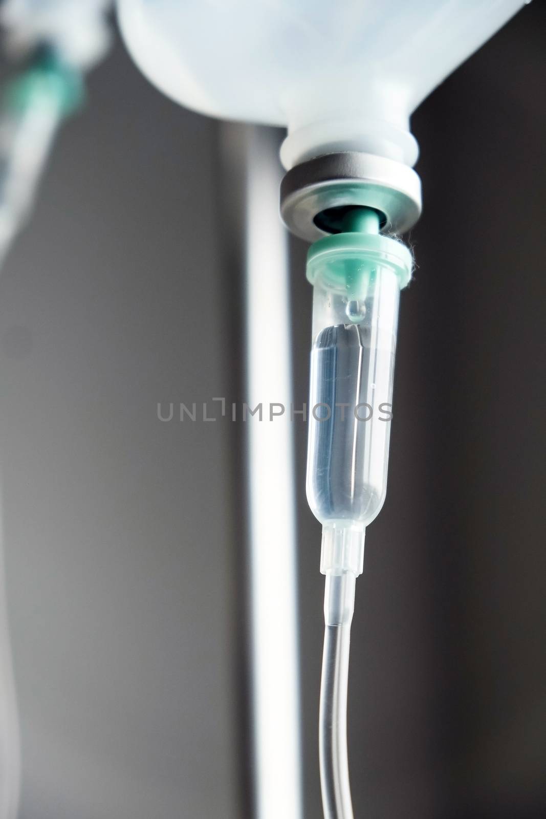 Close up of IV saline solution drip for patient in hospital