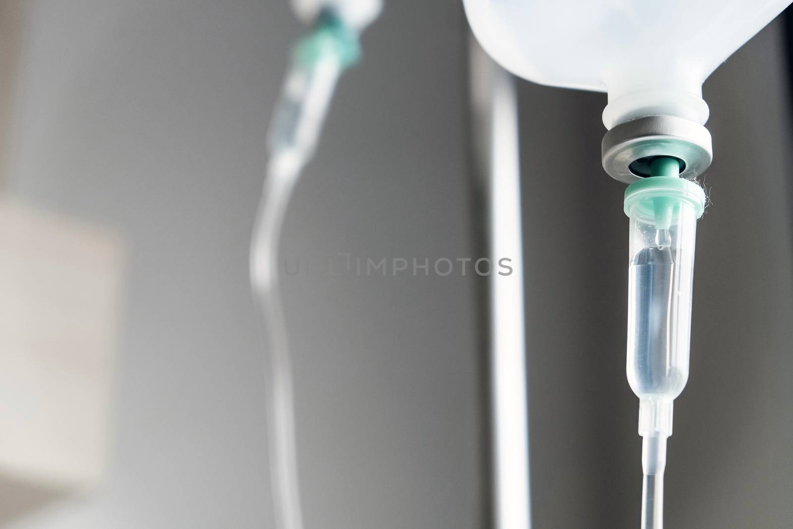 Close up of IV saline solution drip for patient in hospital