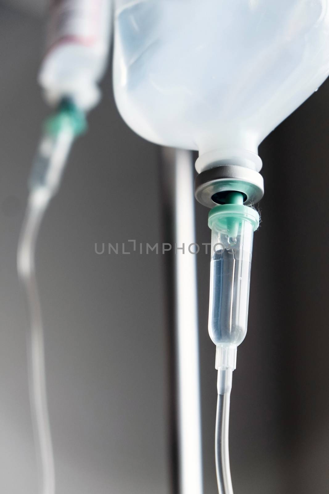 Close up of IV saline solution drip for patient in hospital