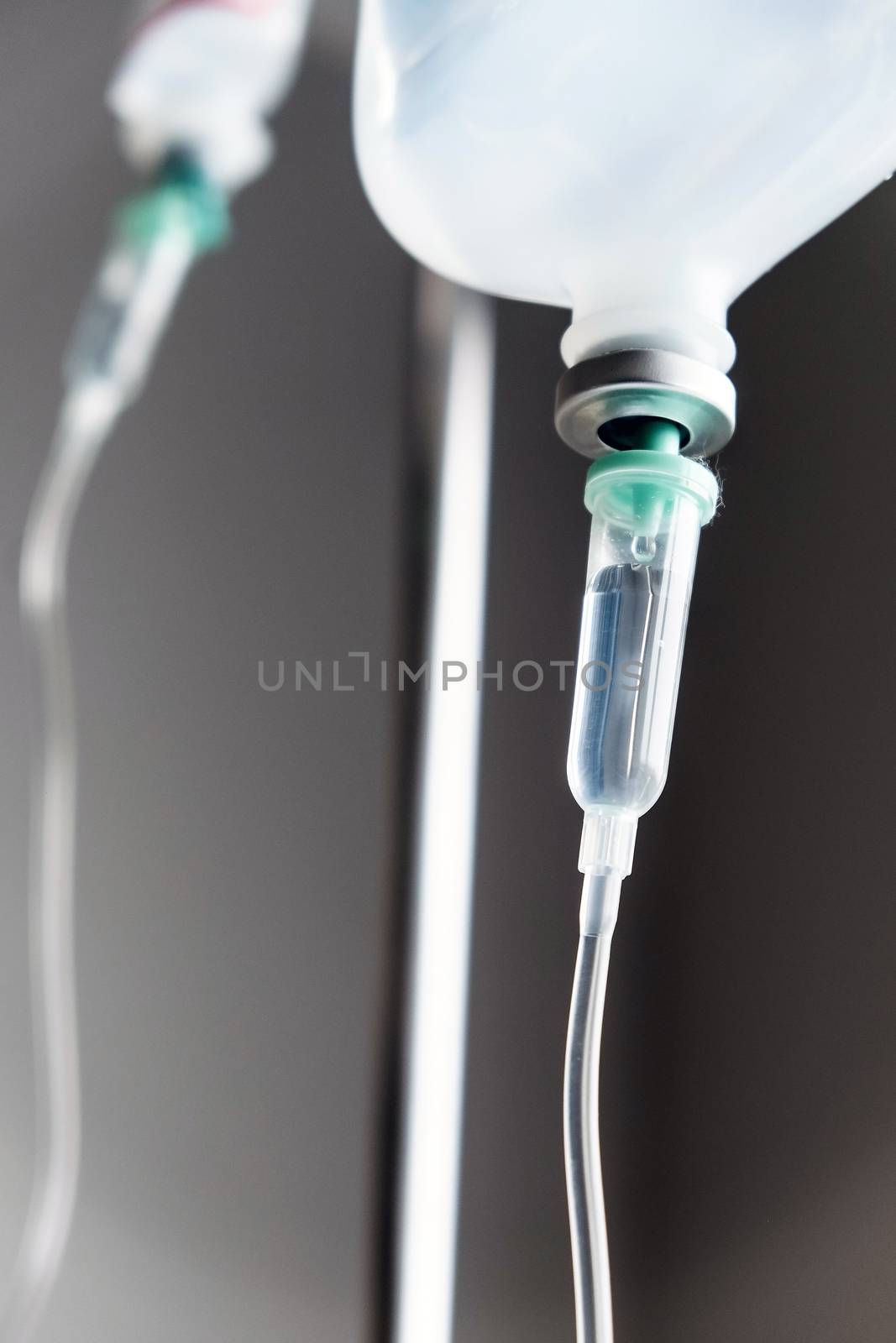 Close up of IV saline solution drip for patient in hospital