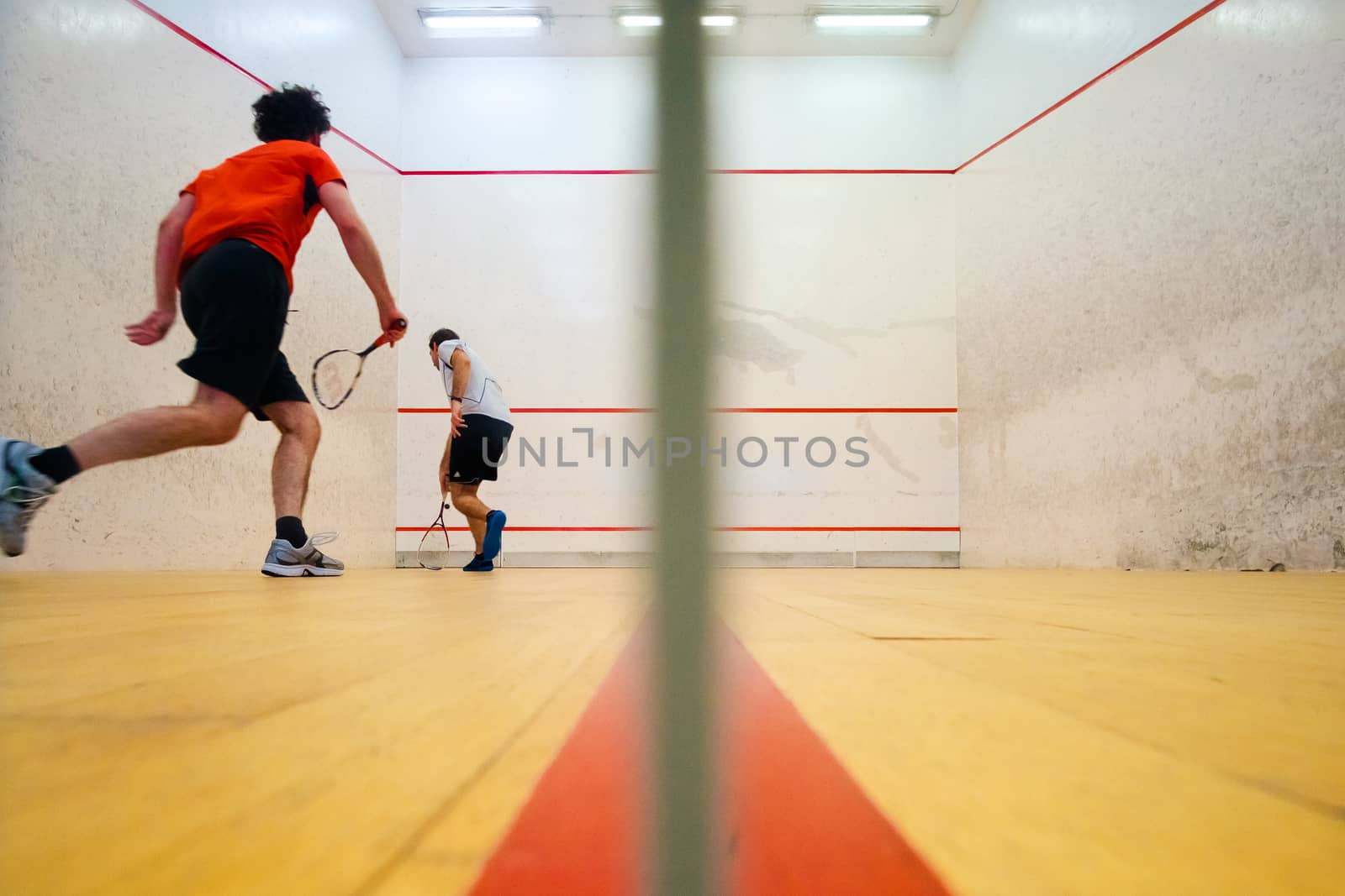 Two friends playing squash in Mutilva, Navarra, Spain by mikelju