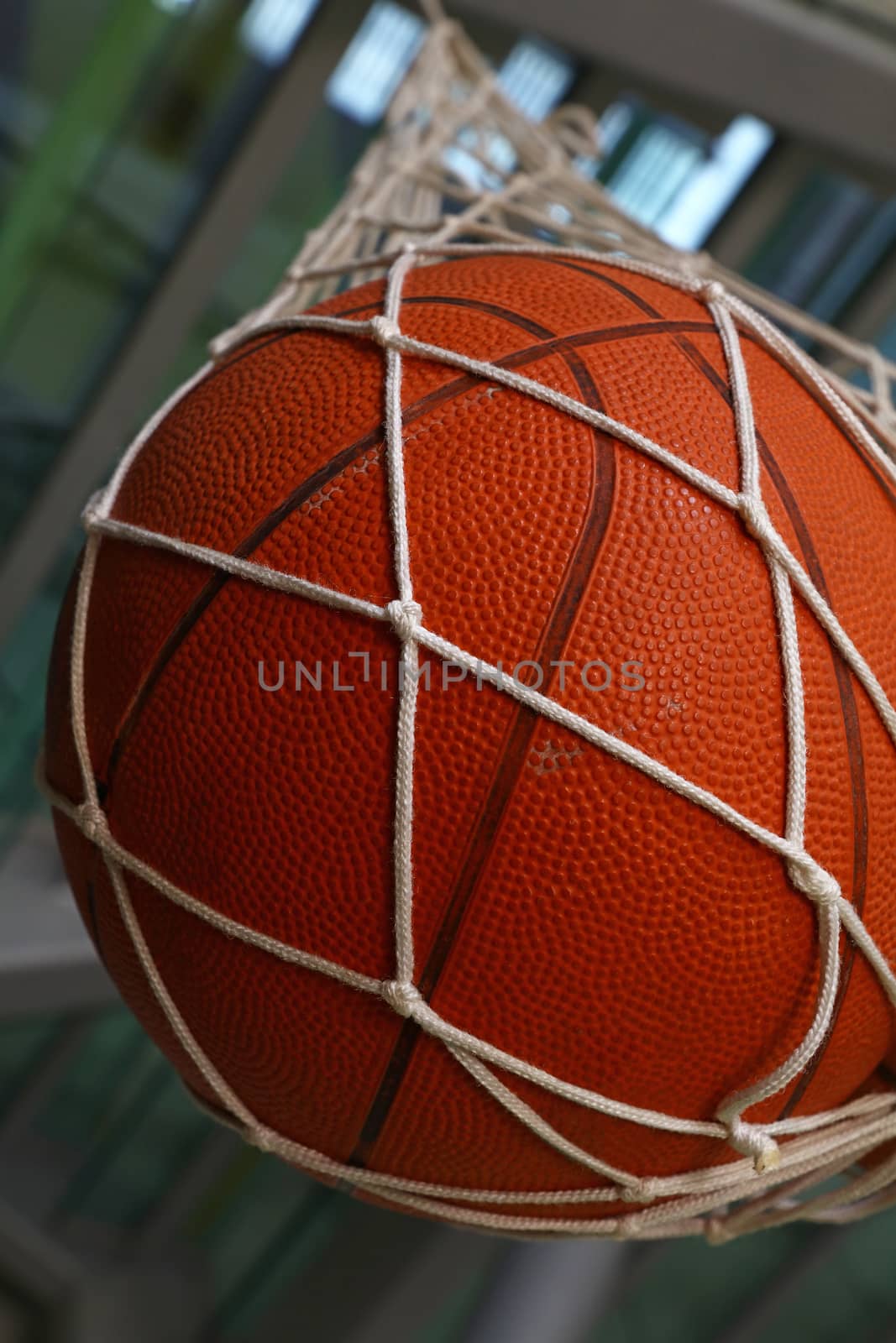 One basketball ball hanging in mesh sack by BreakingTheWalls