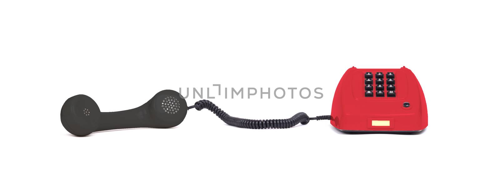 Vintage multi colored telephone with a white background