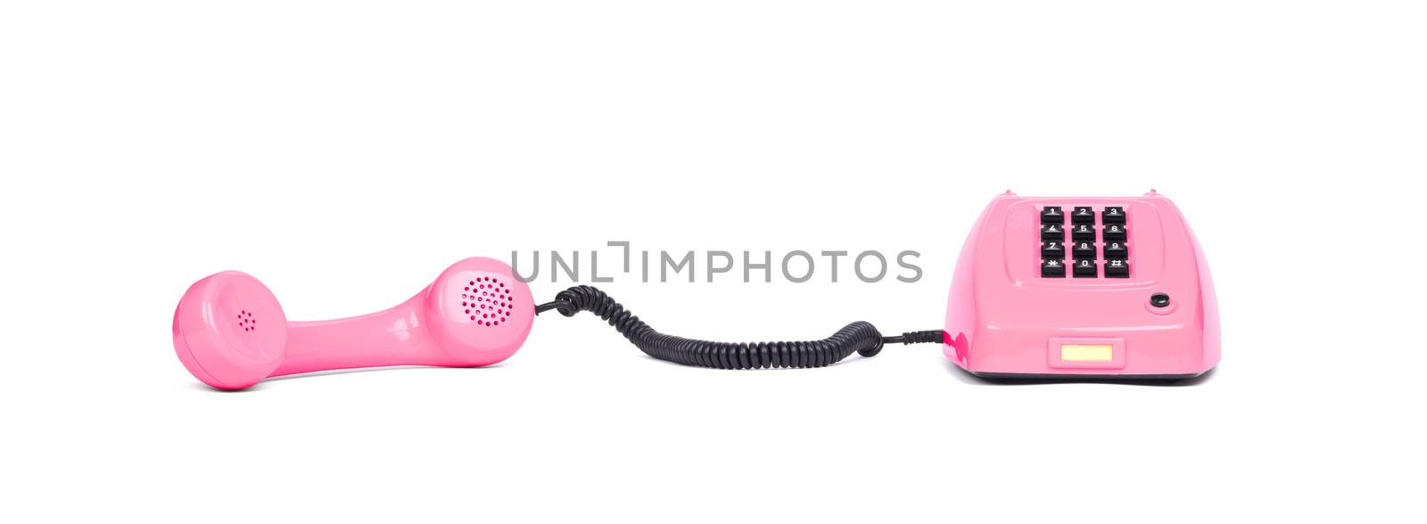 Vintage pink telephone with a white background