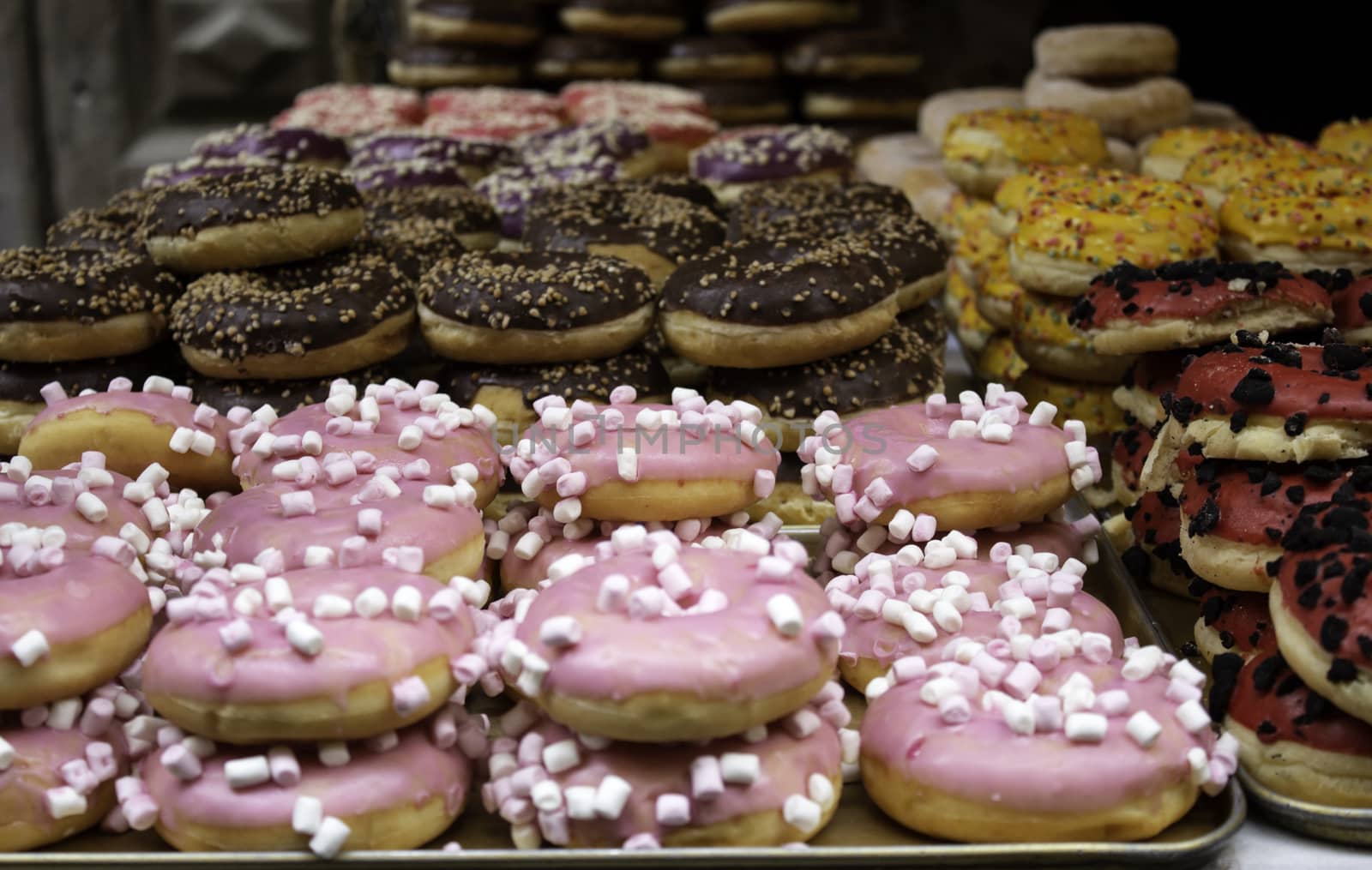 Donuts with chocolate and caramel in pastry, food and desserts