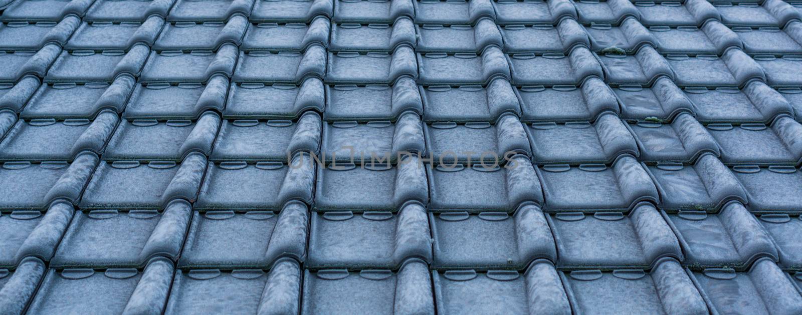 pattern of frozen rooftop tiling in macro closeup, cold winter season, architecture background by charlottebleijenberg