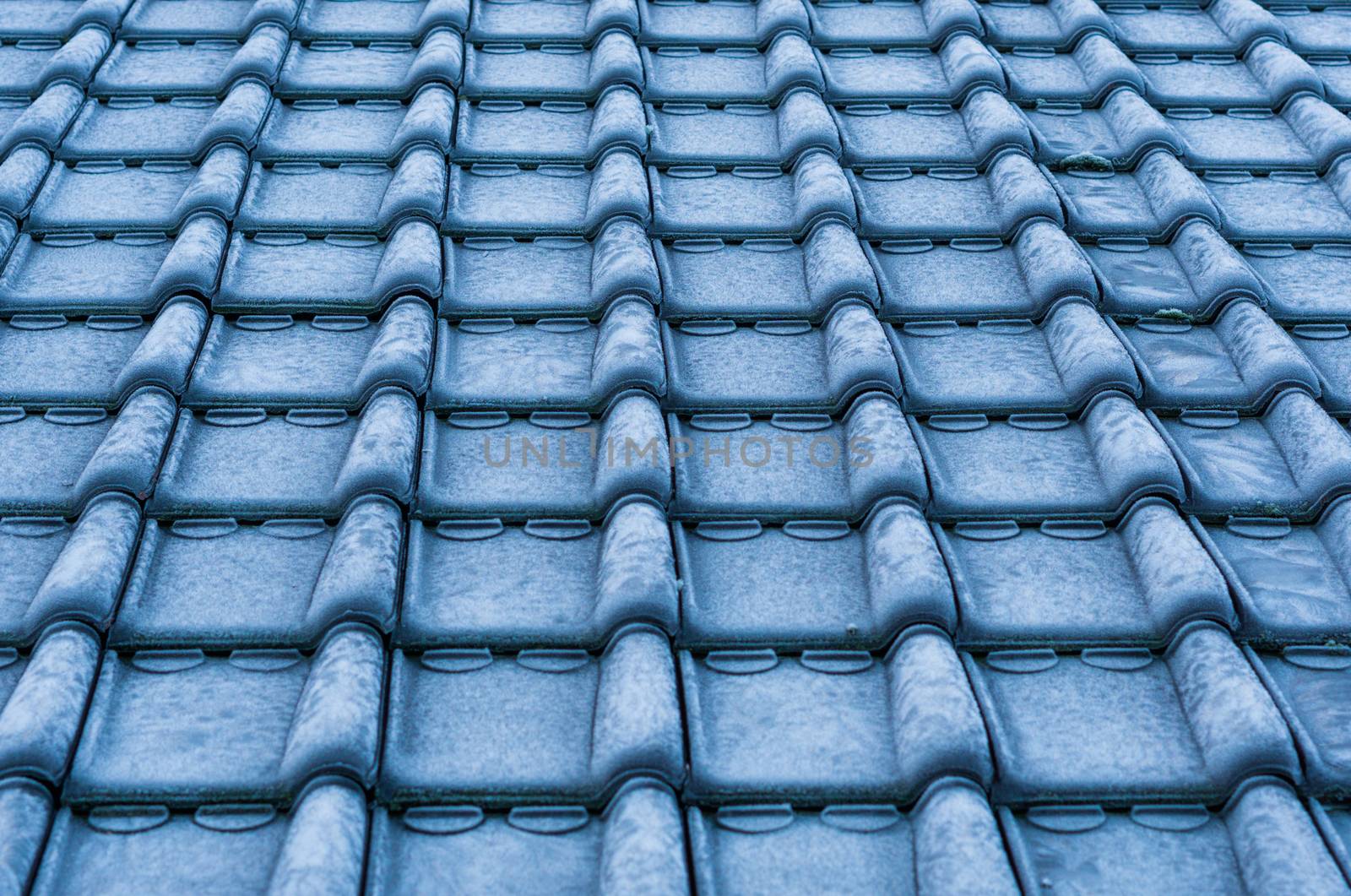 macro closeup of icy rooftop tiling covered in snow crystals, cold winter season, architecture background by charlottebleijenberg