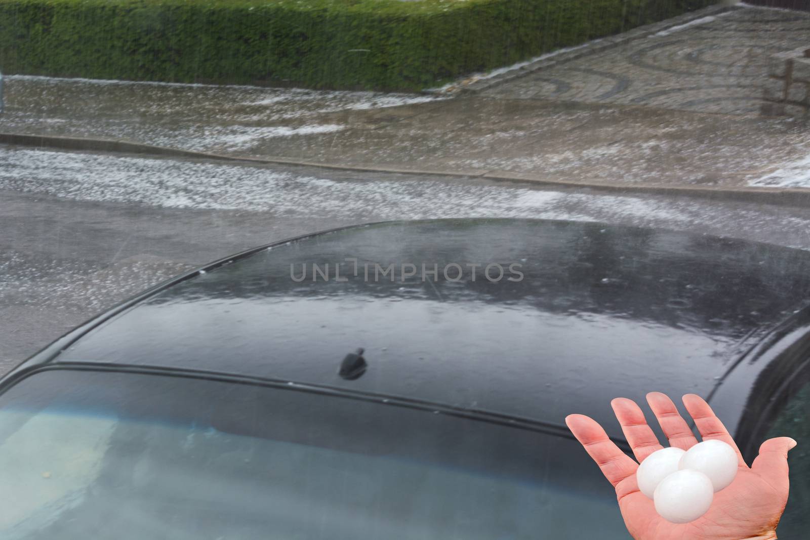 Big hail ice balls on car hood after a heavy hail storm