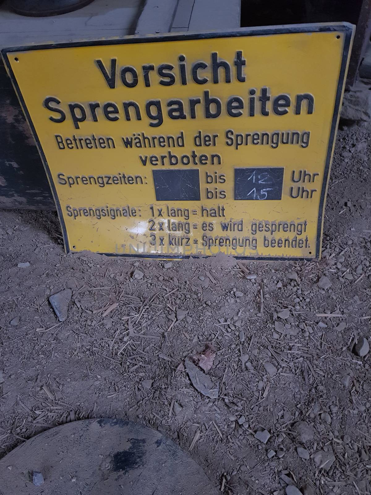 Yellow Warning Sign with Caption in German - Caution Blasting Entering Forbidden
