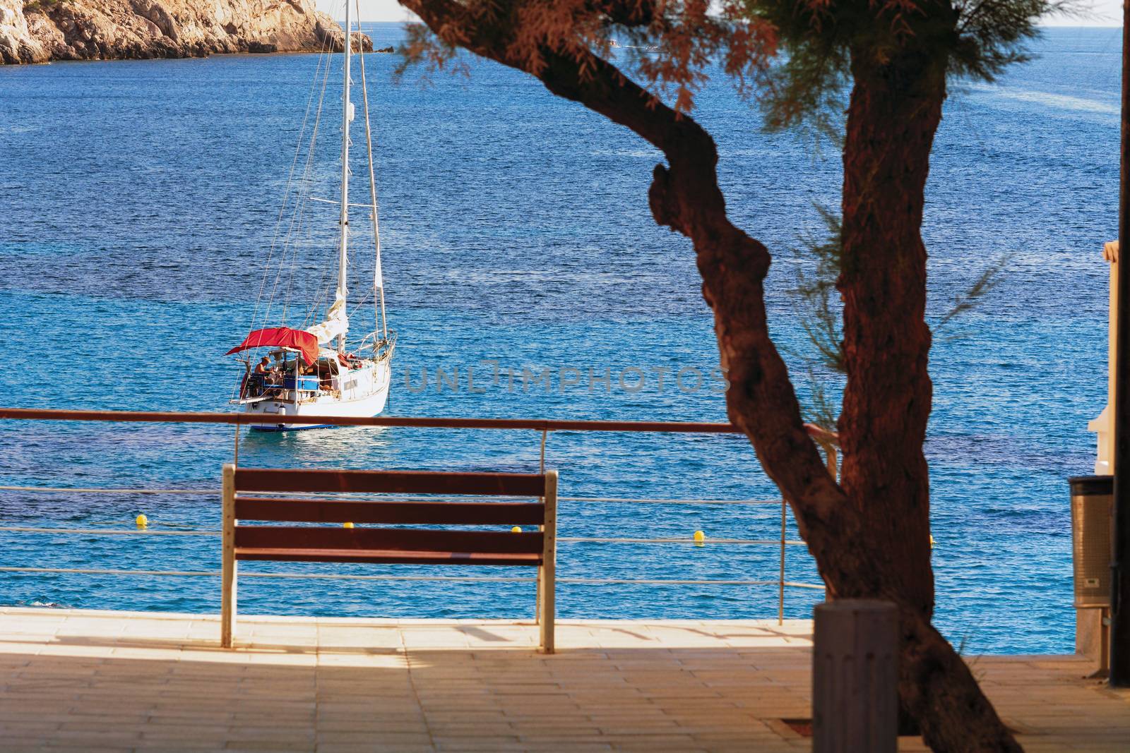 View of a luxury sailboat moored in a bay.