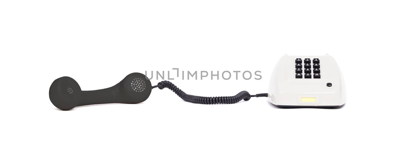 Vintage multi colored telephone with a white background