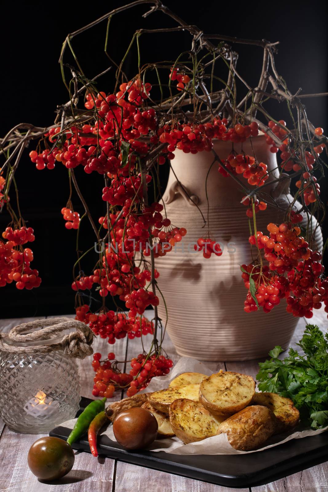 Roasted potatoes and ashberry in ceramic vase