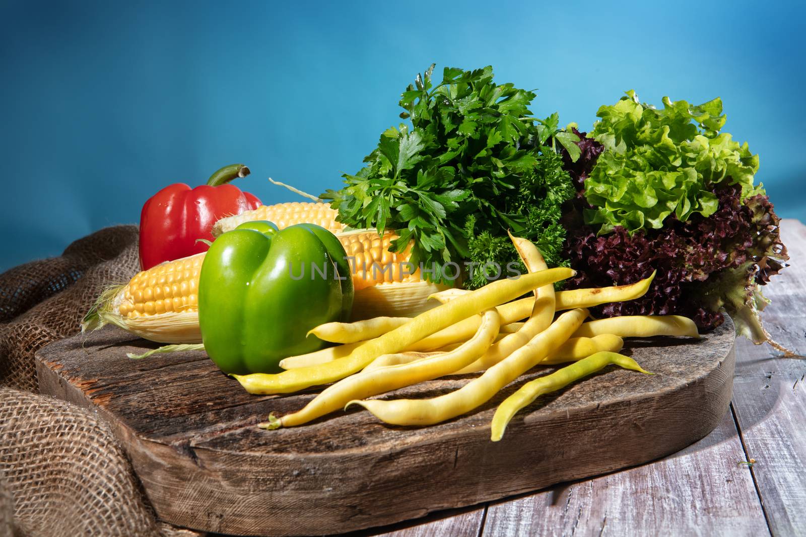 Maize, greenery and pepper on a wooden table