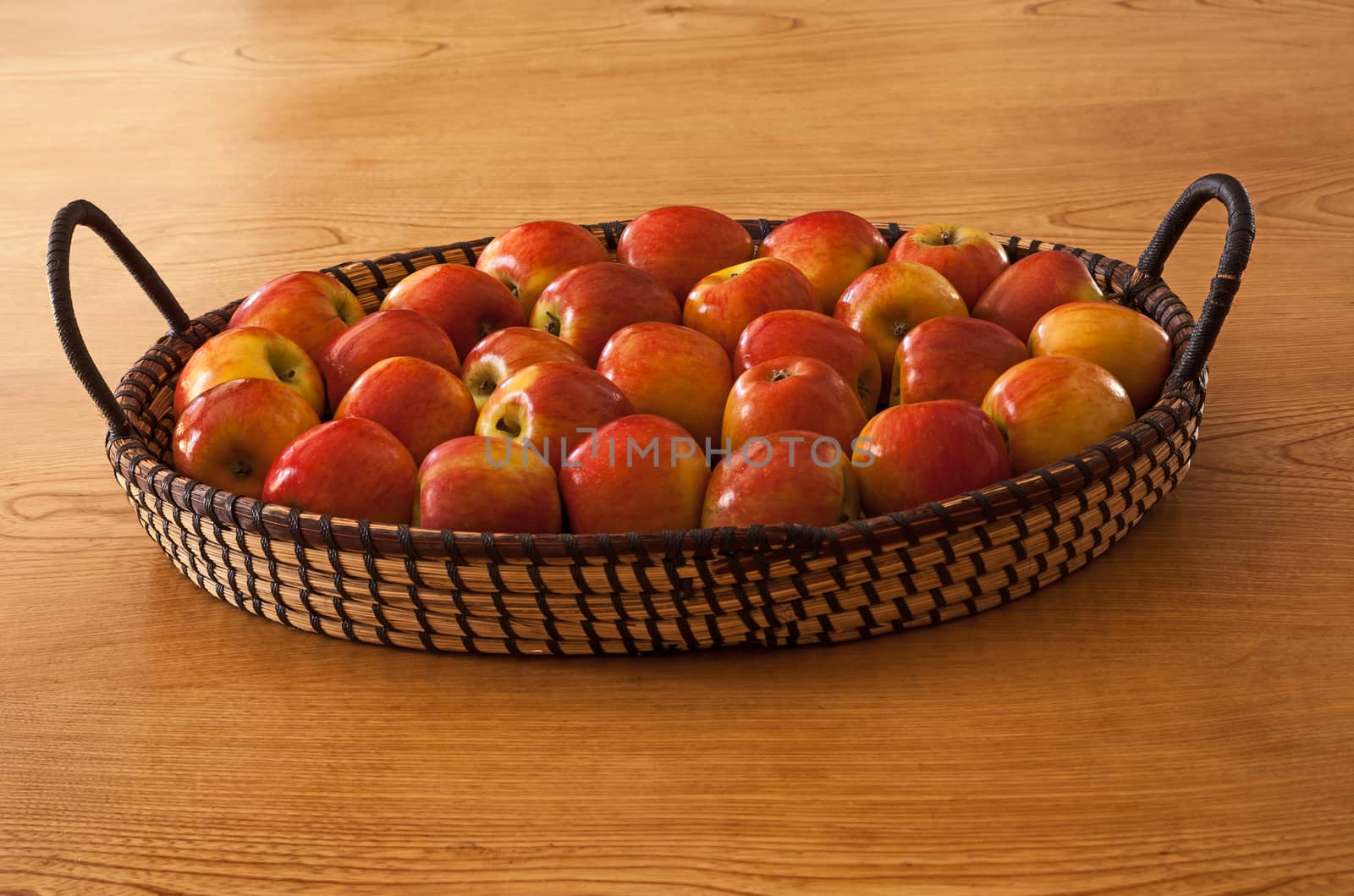 Still life image of a basket of freshly picked apples.