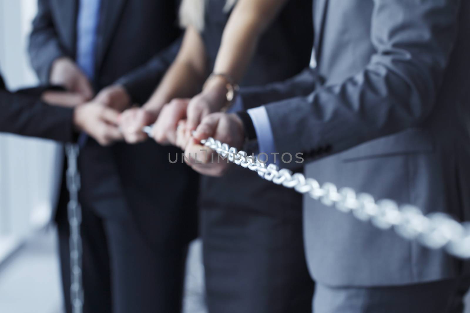Businessmen pulling chain, teamwork togetherness concept