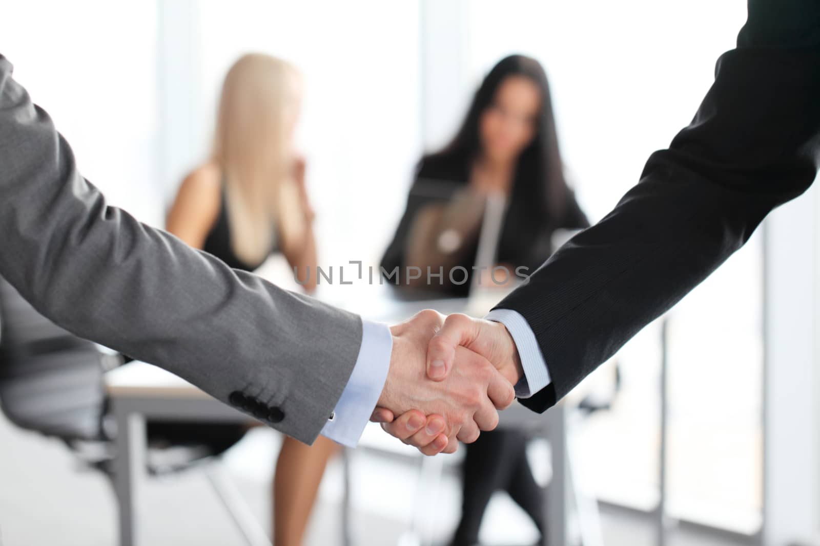 Close-up of handshake of businessmen on meeting in office