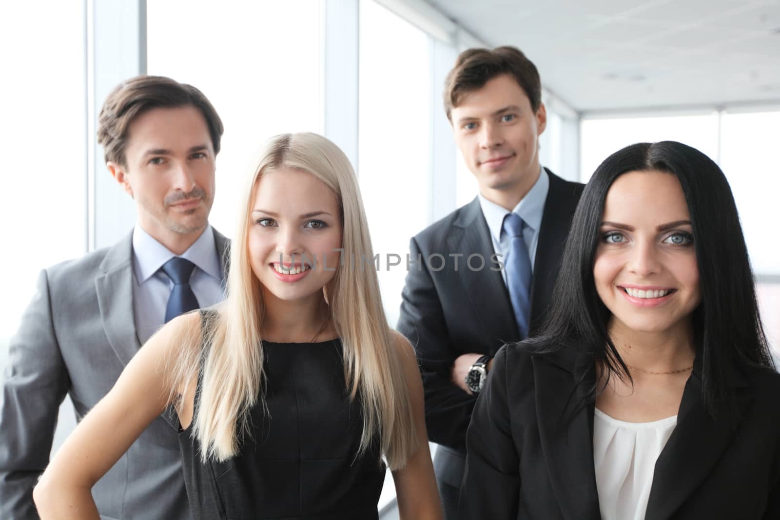 Happy business team of coworkers in office