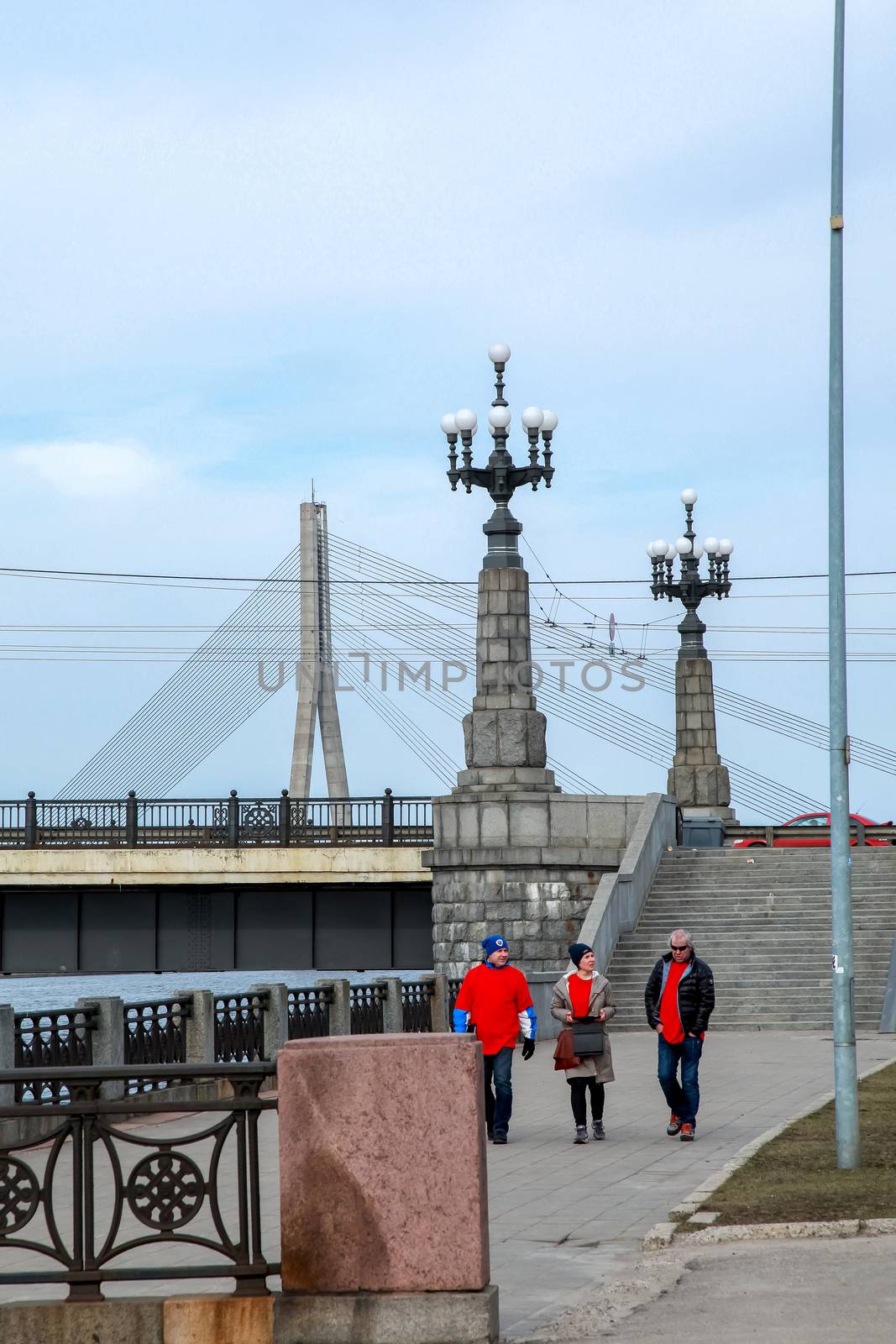 View of the Akmens bridge from the 11th November Embankment. Stairs to the stone bridge and lanterns in Riga, Latvia. Behind the Akmens bridge-  Vansu bridge. Stone bridge in Riga city.