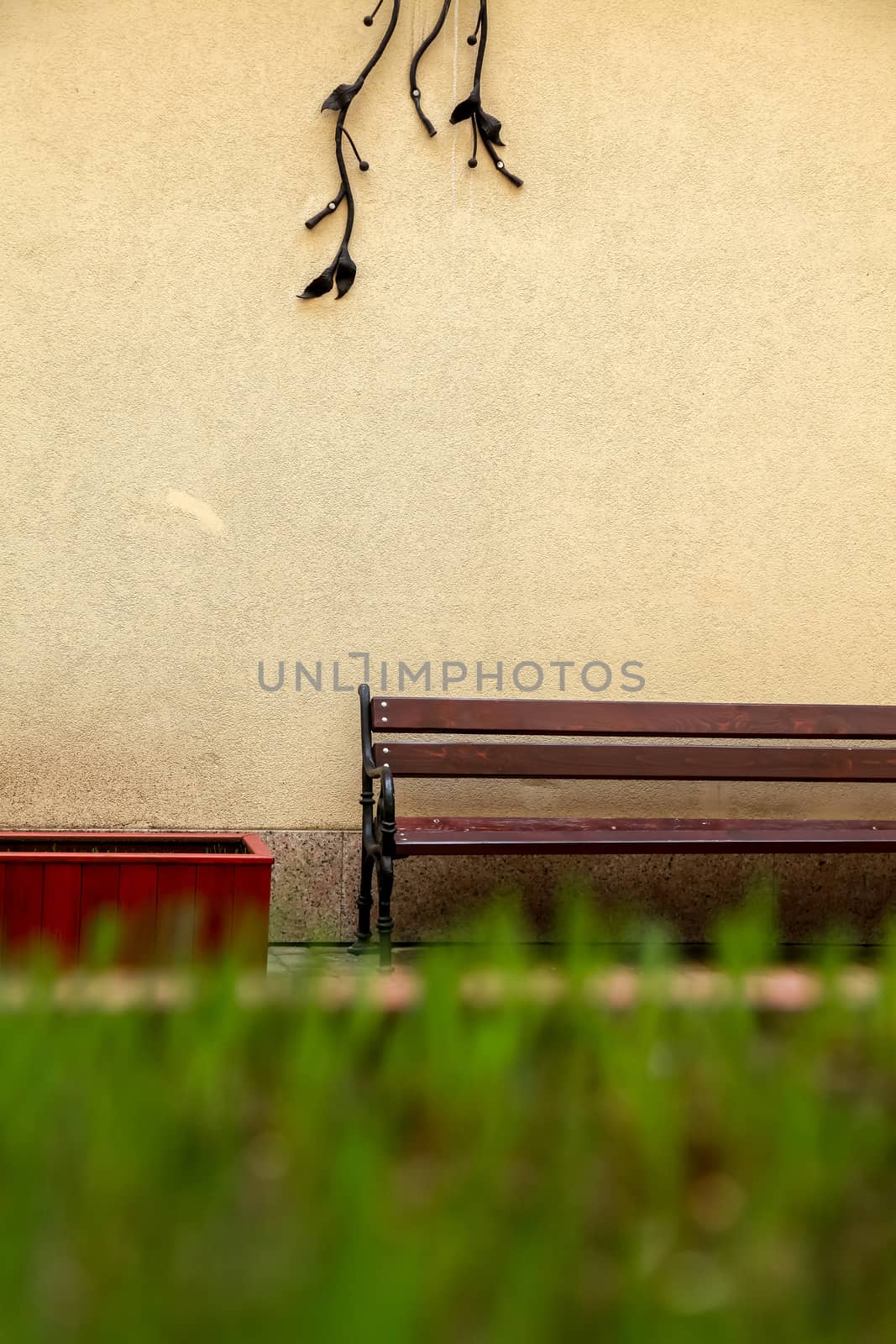 Fragment of yellow wall with bench in Old Riga, Latvia. Bench at the wall in Riga city.
