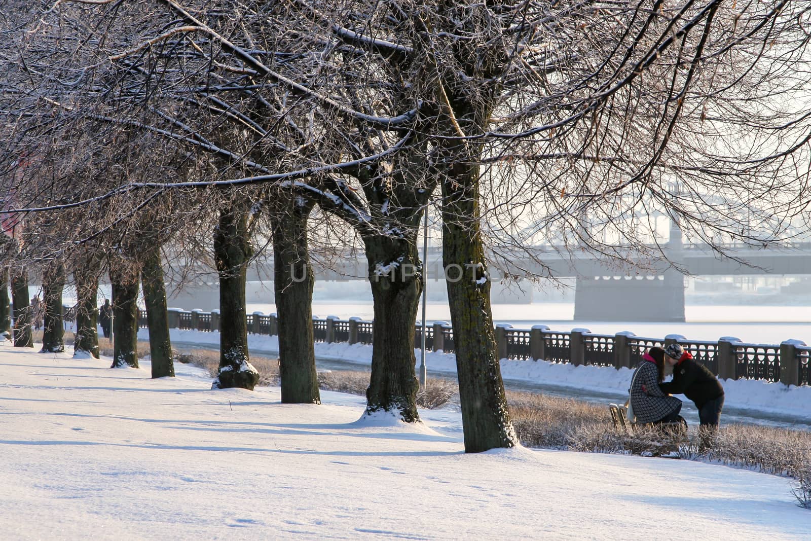 View of Riga from the 11th November Embankment side. Riga view in winter. Frozen river Daugava at the 11th November Embankment.