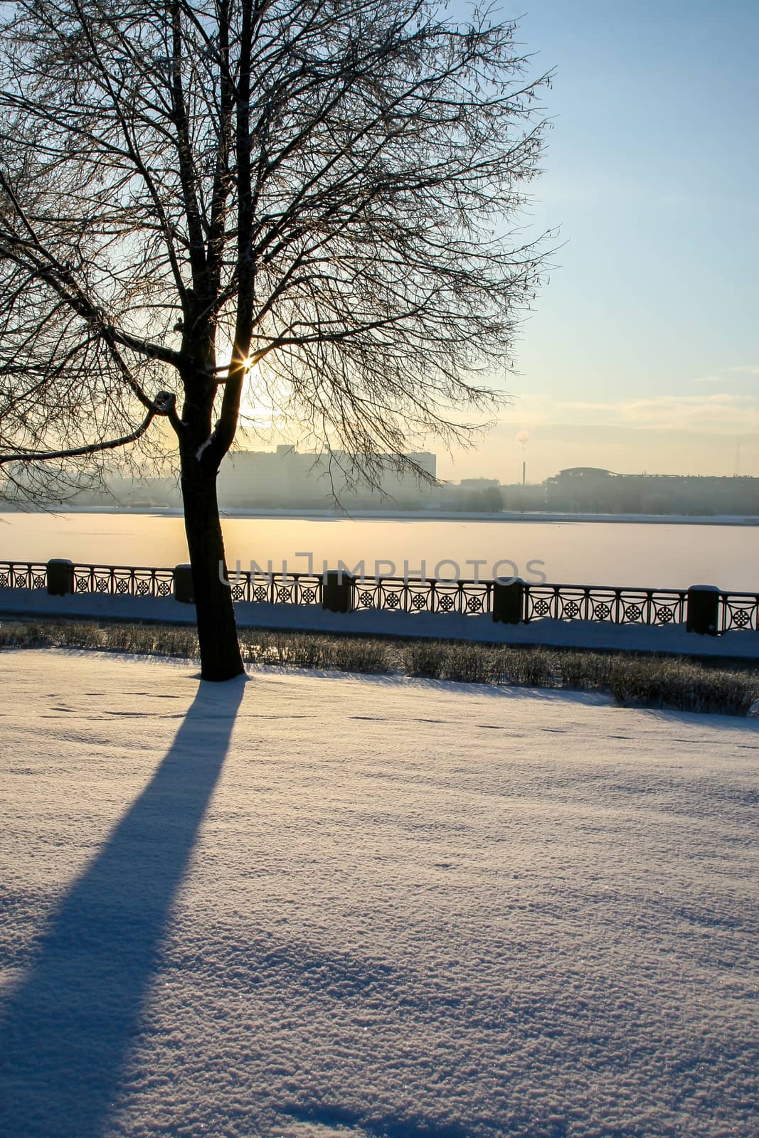 View of Riga from the 11th November Embankment side. Riga view in winter. Frozen river Daugava at the 11th November Embankment.