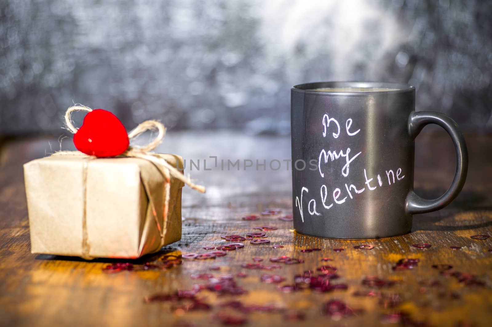 Valentine's day concept with black cup, chalk inscription on a mug and a red heart.