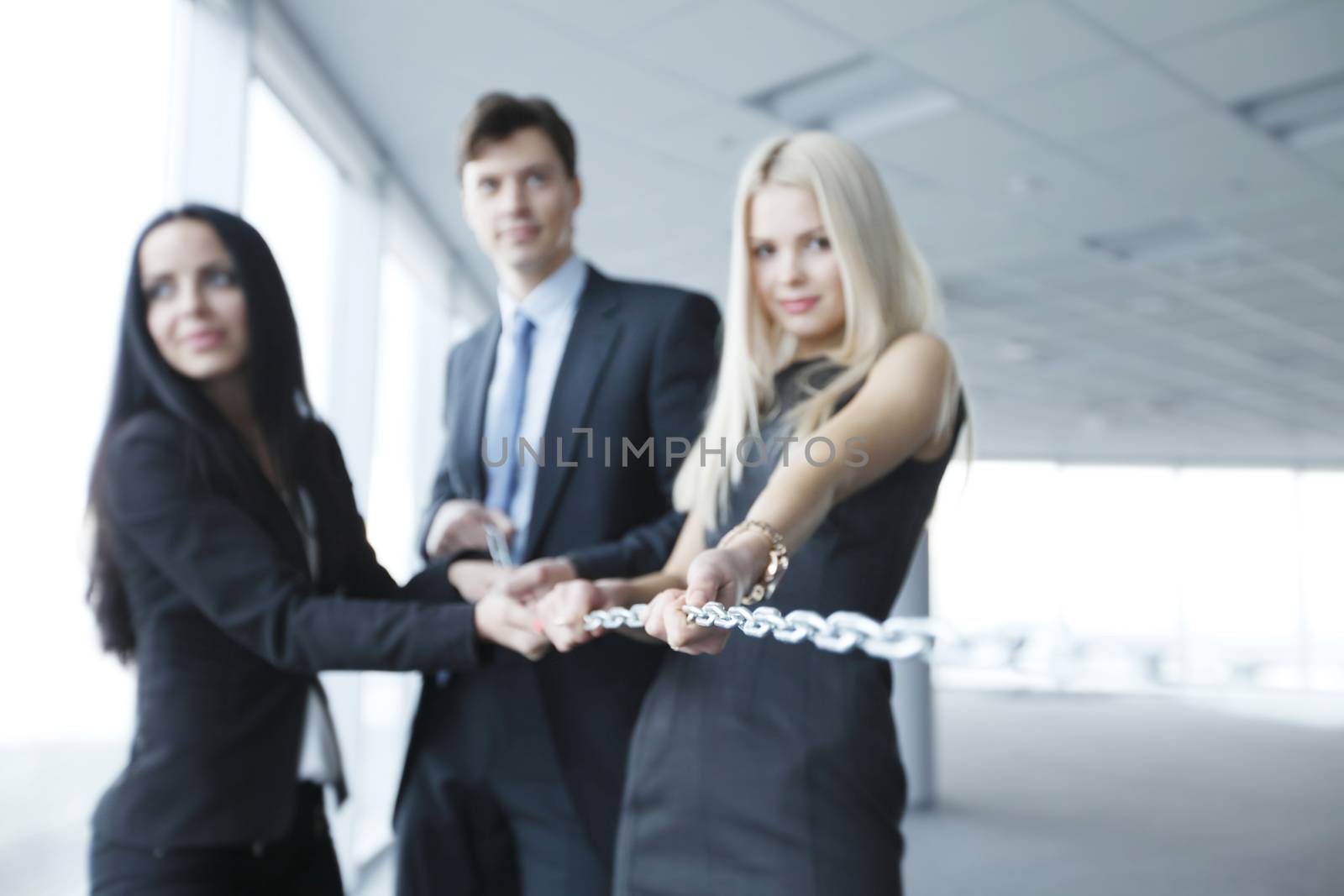 Businessmen pulling chain, teamwork togetherness concept