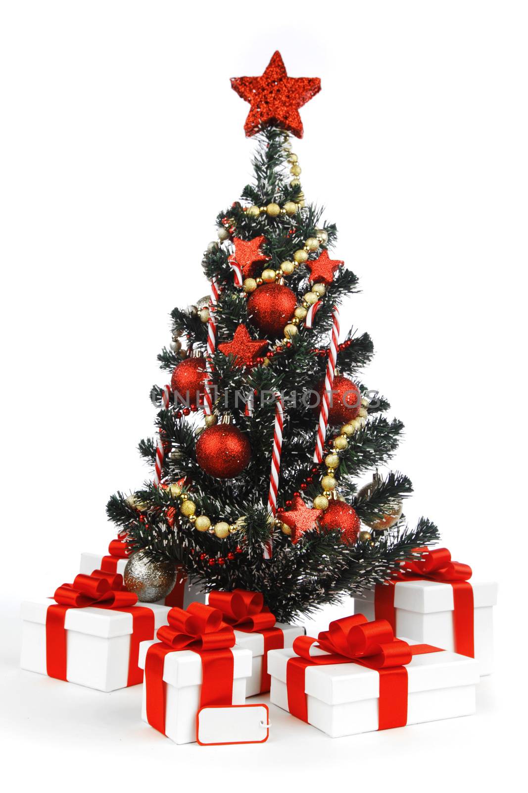 Decorated Christmas tree and presents isolated on white background