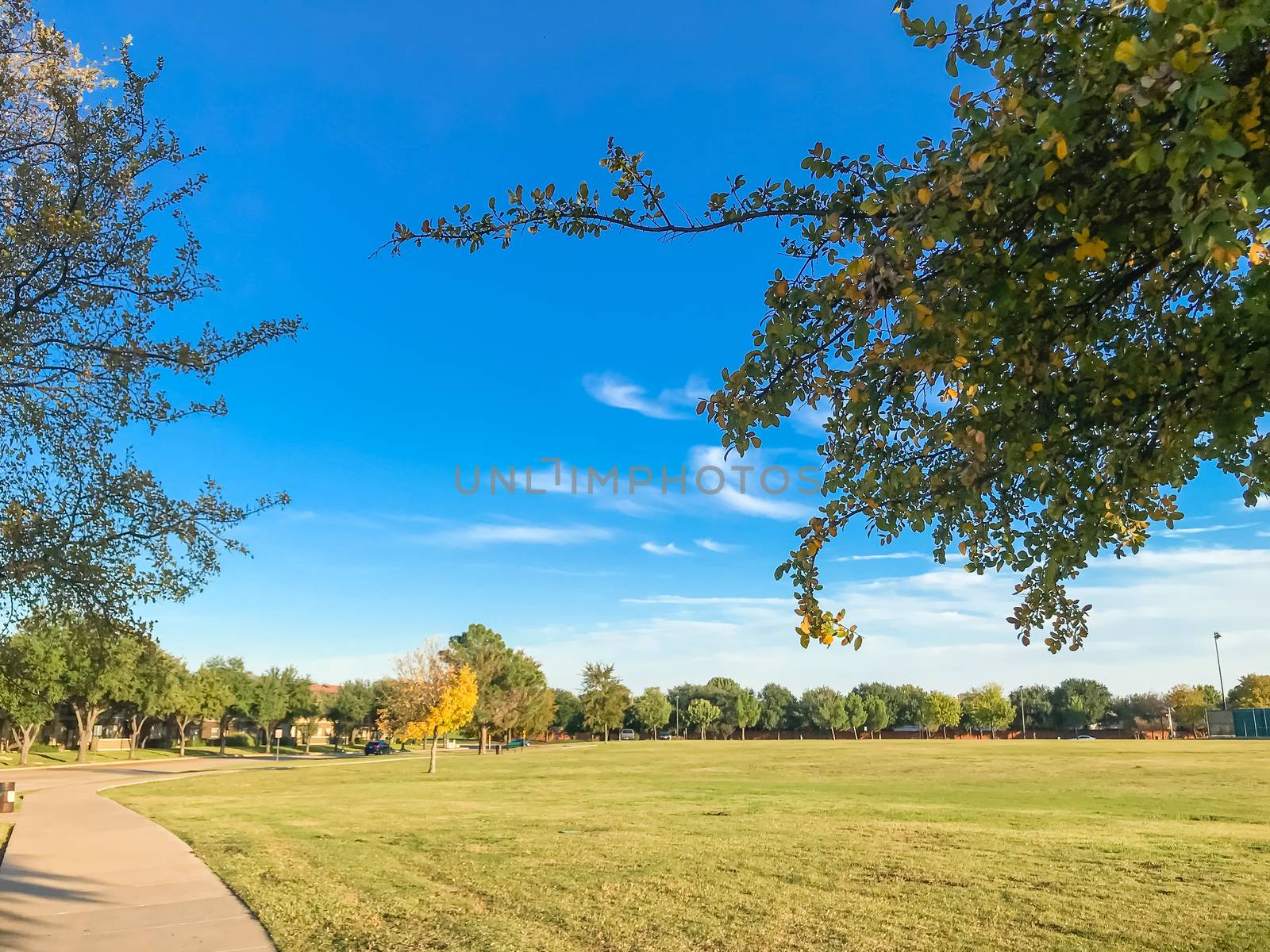 Empty curved pathway in city park suburbs of Dallas, Texas, USA