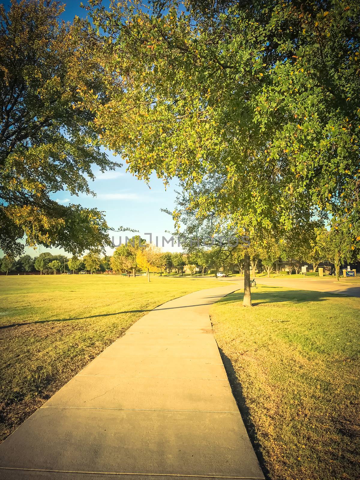 Vintage tone image of empty curved pathway in city park suburbs of Dallas, Texas, USA