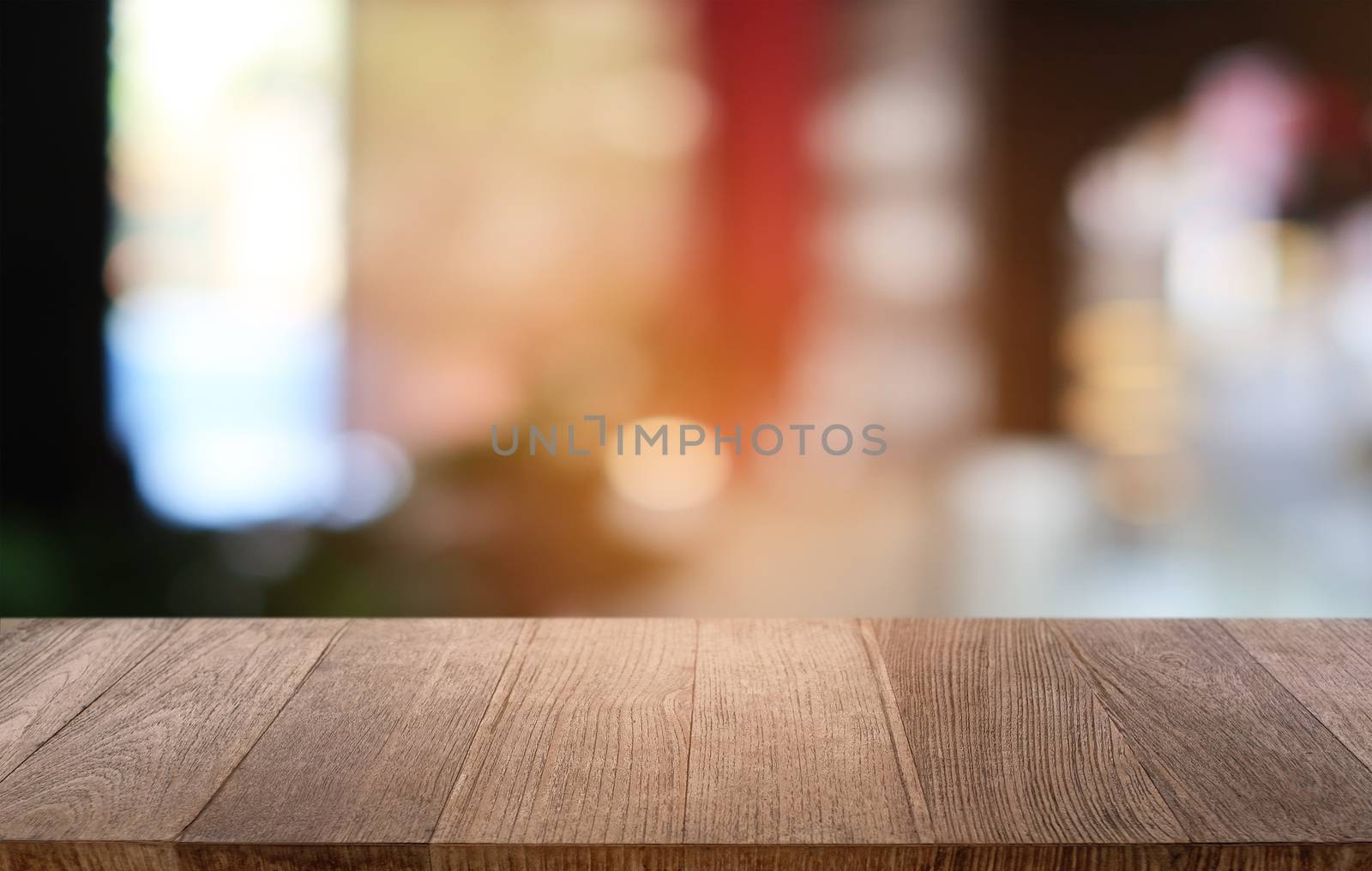 Empty dark wooden table in front of abstract blurred bokeh backg by peandben