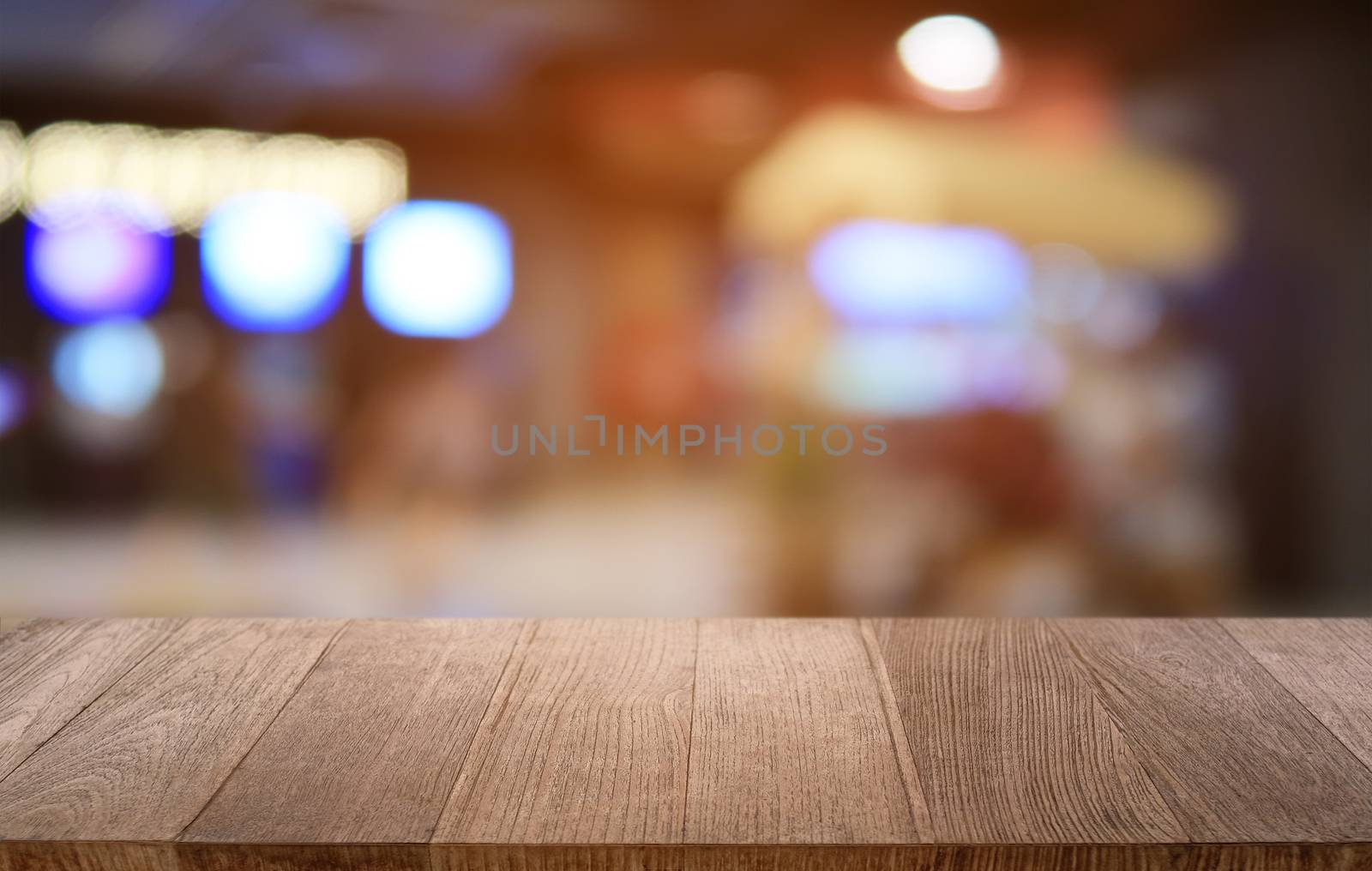 Empty dark wooden table in front of abstract blurred bokeh backg by peandben