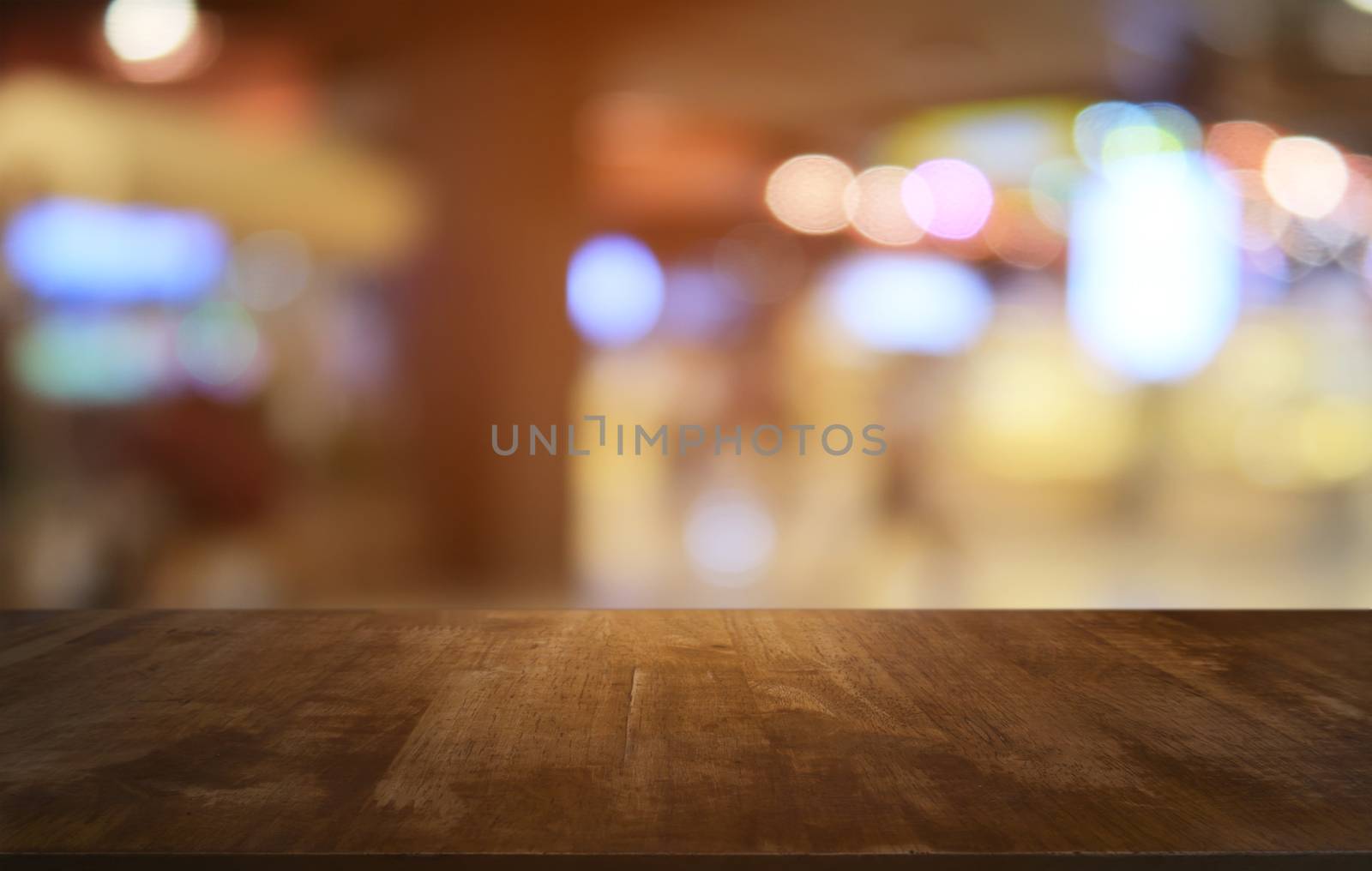 Empty dark wooden table in front of abstract blurred bokeh backg by peandben