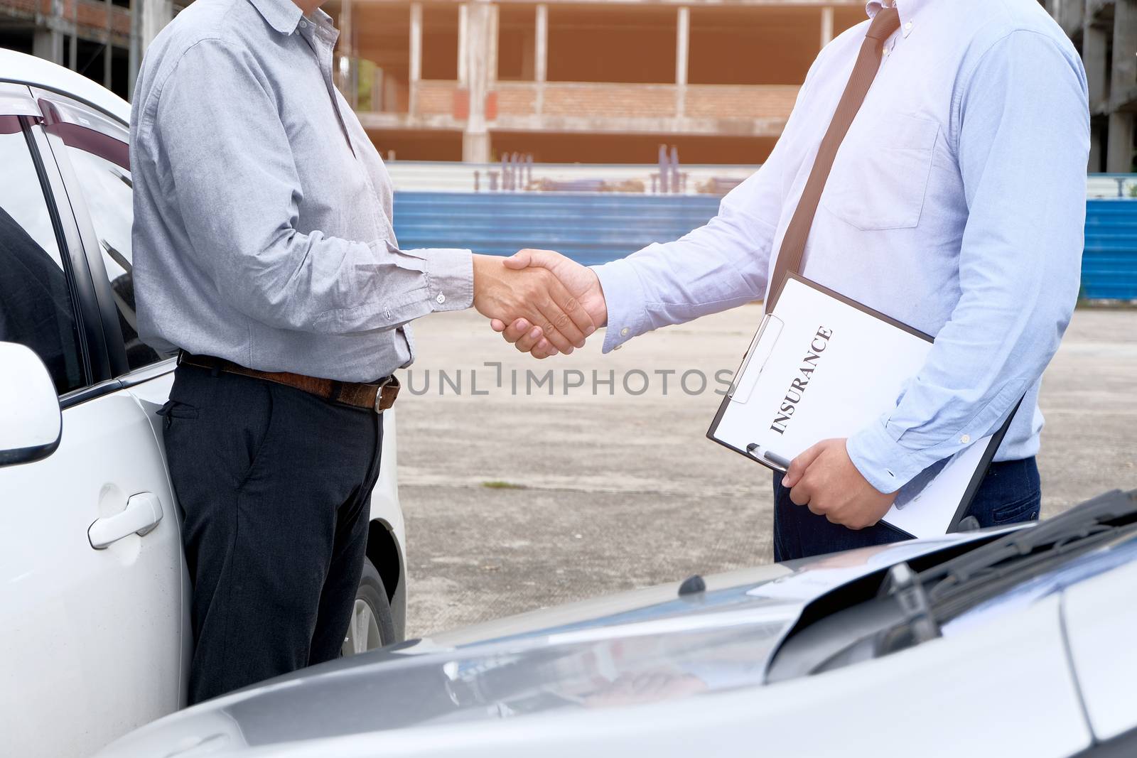 Loss Adjuster Insurance Agent Inspecting Damaged Car. by peandben