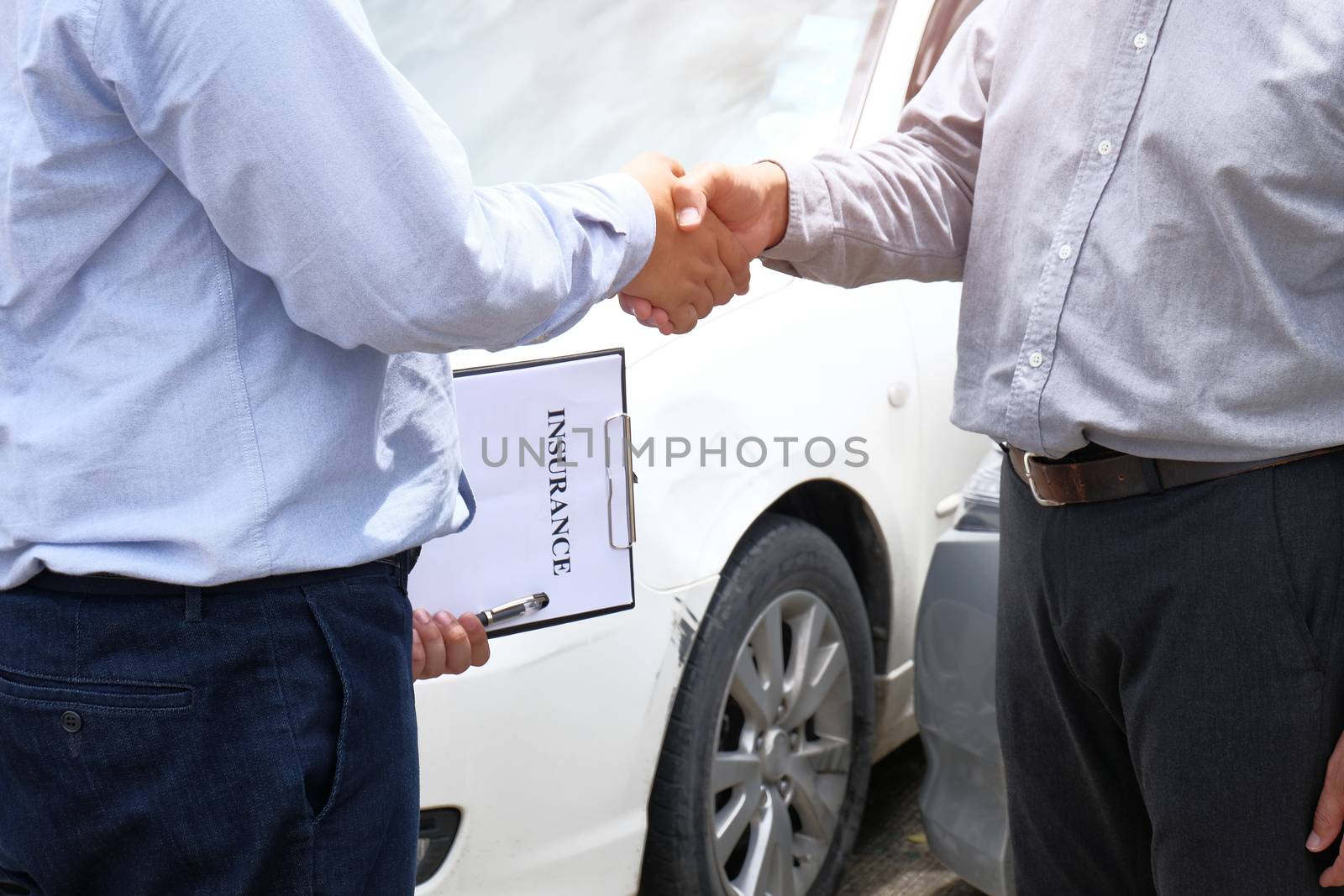 Loss Adjuster Insurance Agent Inspecting Damaged Car. by peandben