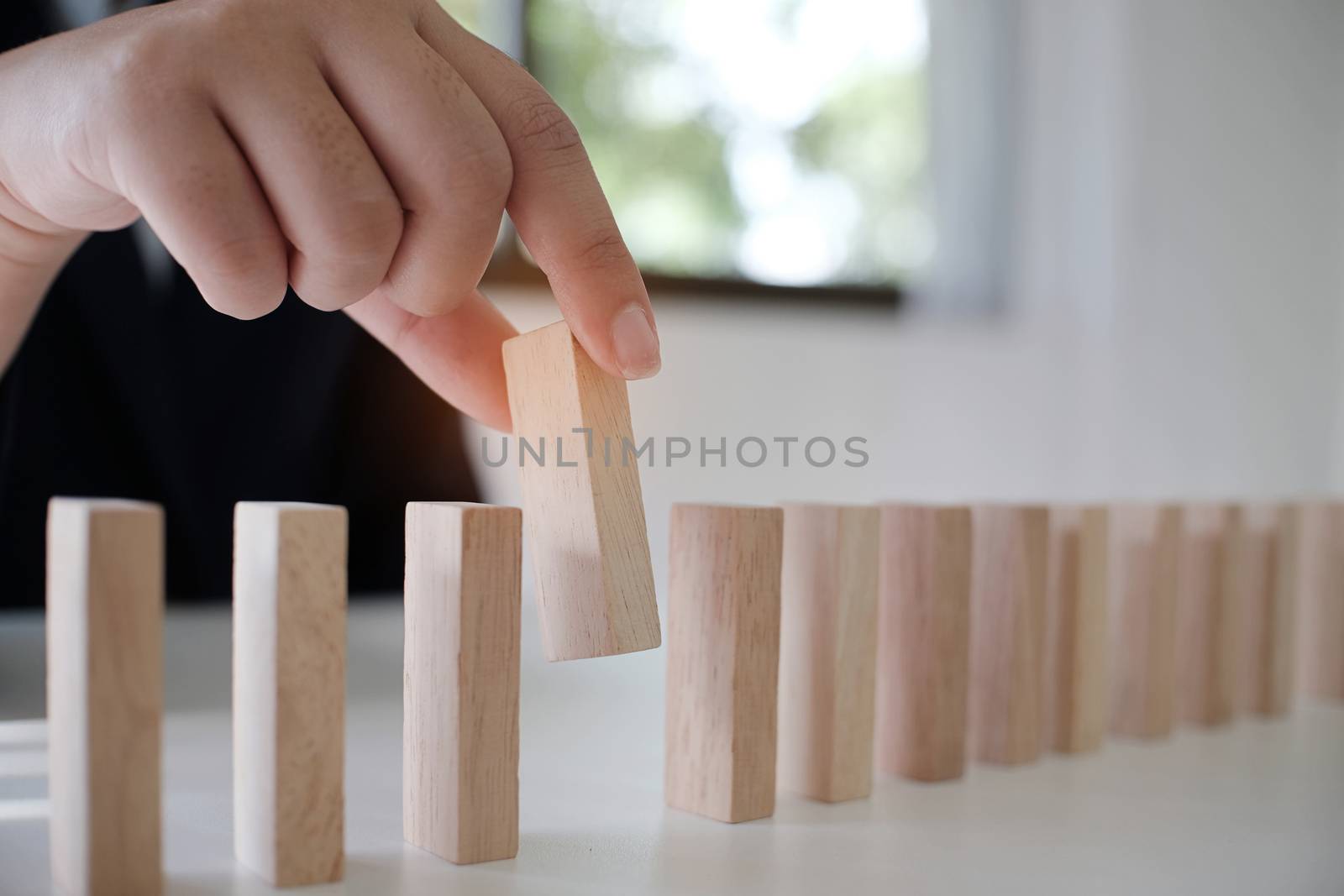 Planning risk and strategy in businessman gambling placing wooden block.Business concept for growth success process.