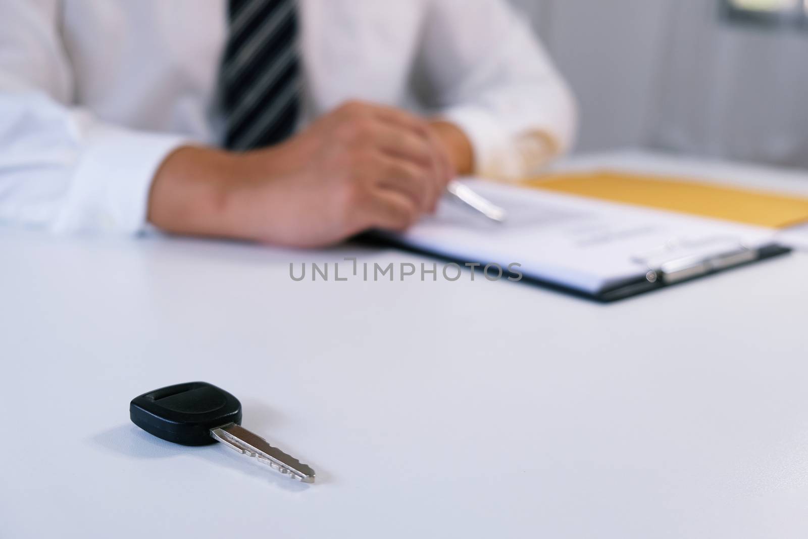 Car salesman handing over the keys for a new car. by peandben