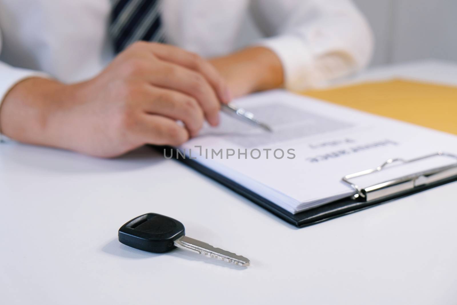 Car salesman handing over the keys for a new car