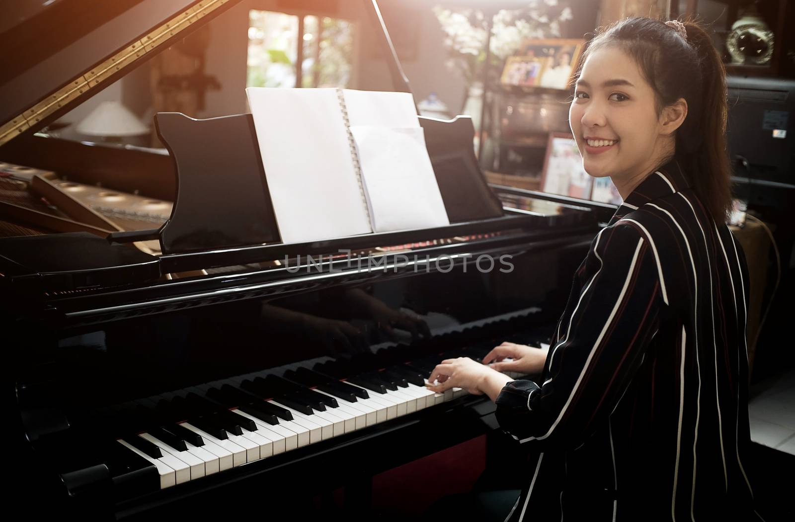 Beautiful asian girl learn to play piano