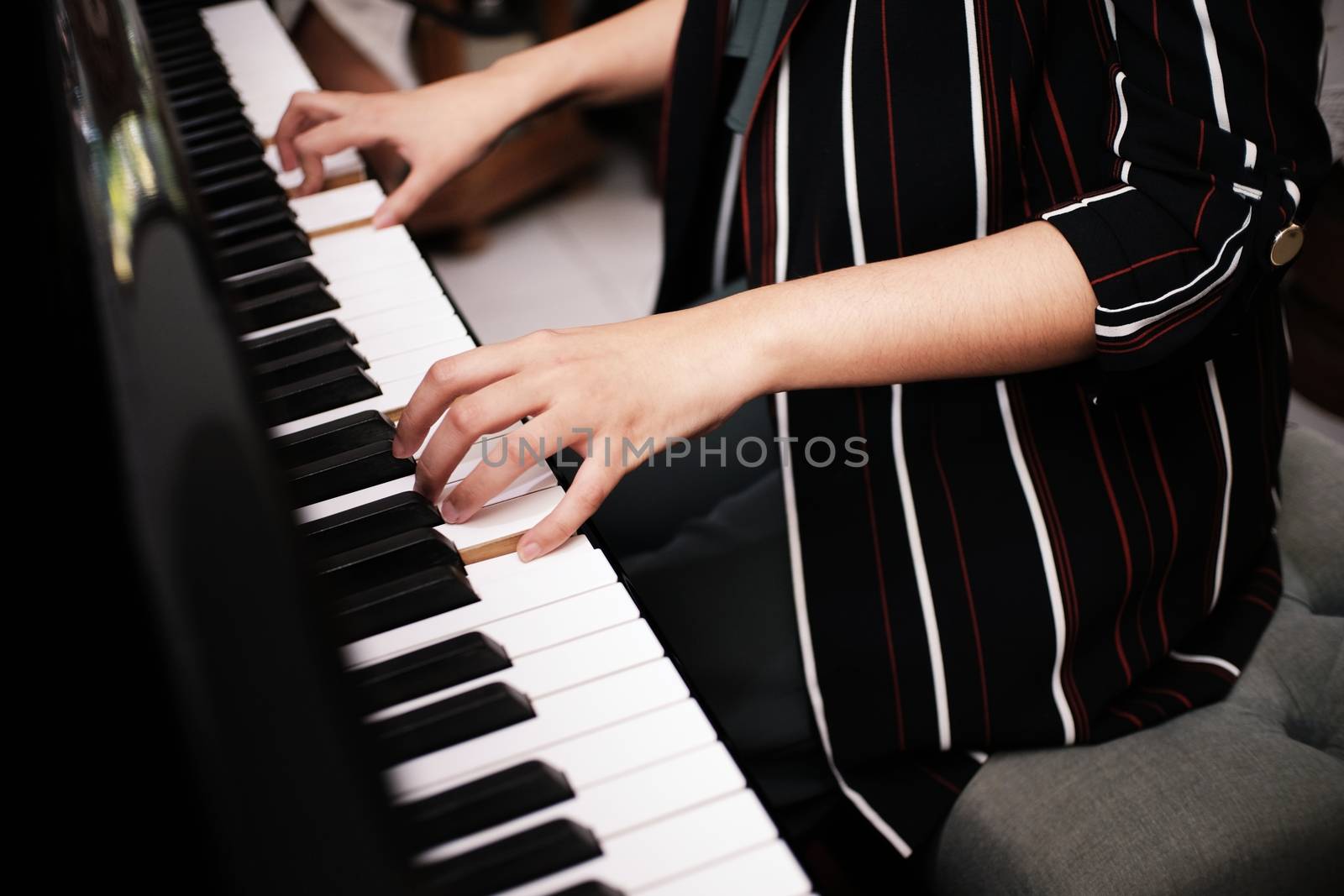 Beautiful asian girl learn to play piano